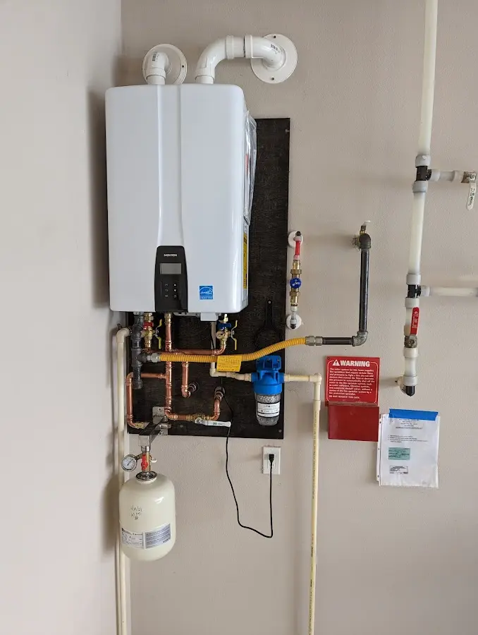 Professional plumber installing copper piping in a Green Hill home